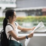 Female tourist with city map looking destination