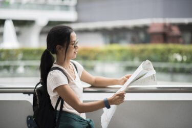 Female tourist with city map looking destination