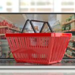 Supermarket online shopping. Shopping basket on a laptop.3d illustration