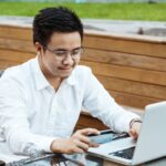 Young Handsome man enjoy shopping online on mobile phone with credit card