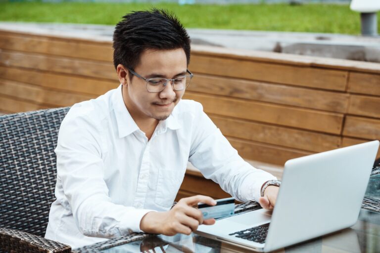 Young Handsome man enjoy shopping online on mobile phone with credit card