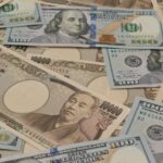 Stack of Japanese yen and USD