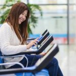 passenger holding and scanning mobile phone with qr code scanner machine of message chair